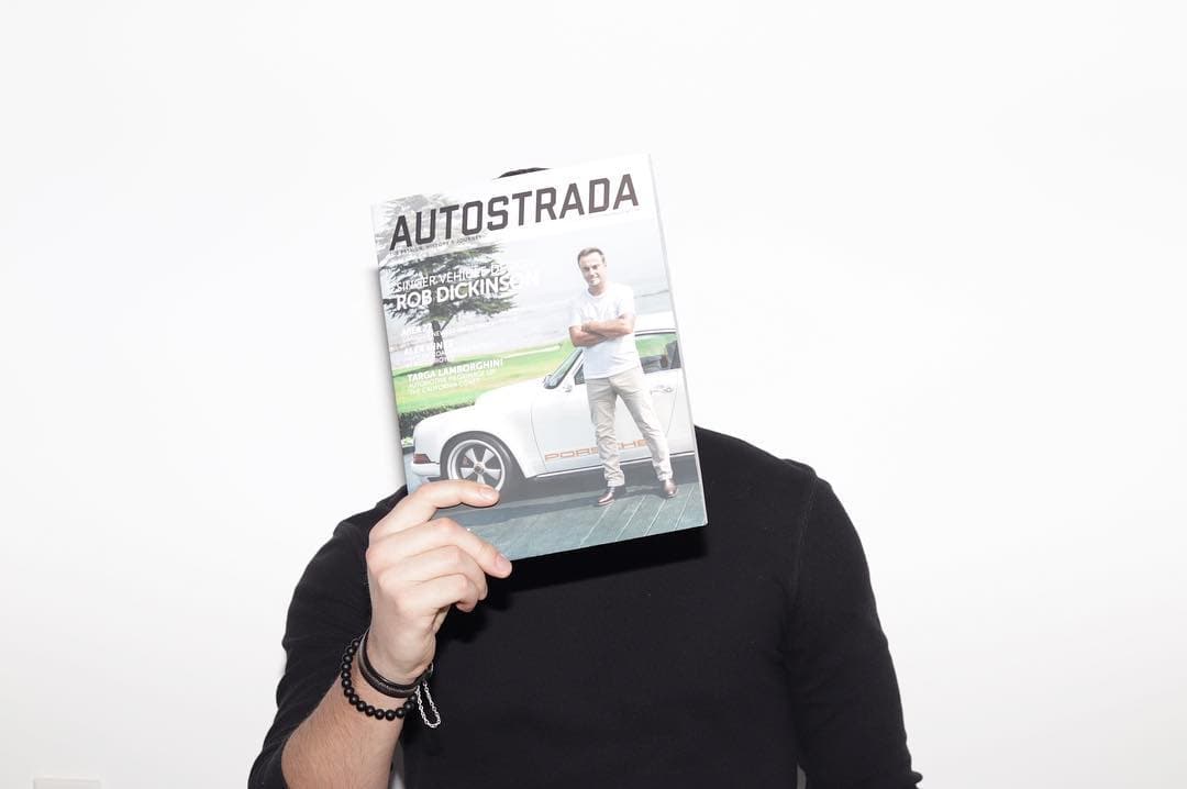 Holding an Autostrada Magazine cover over my face.