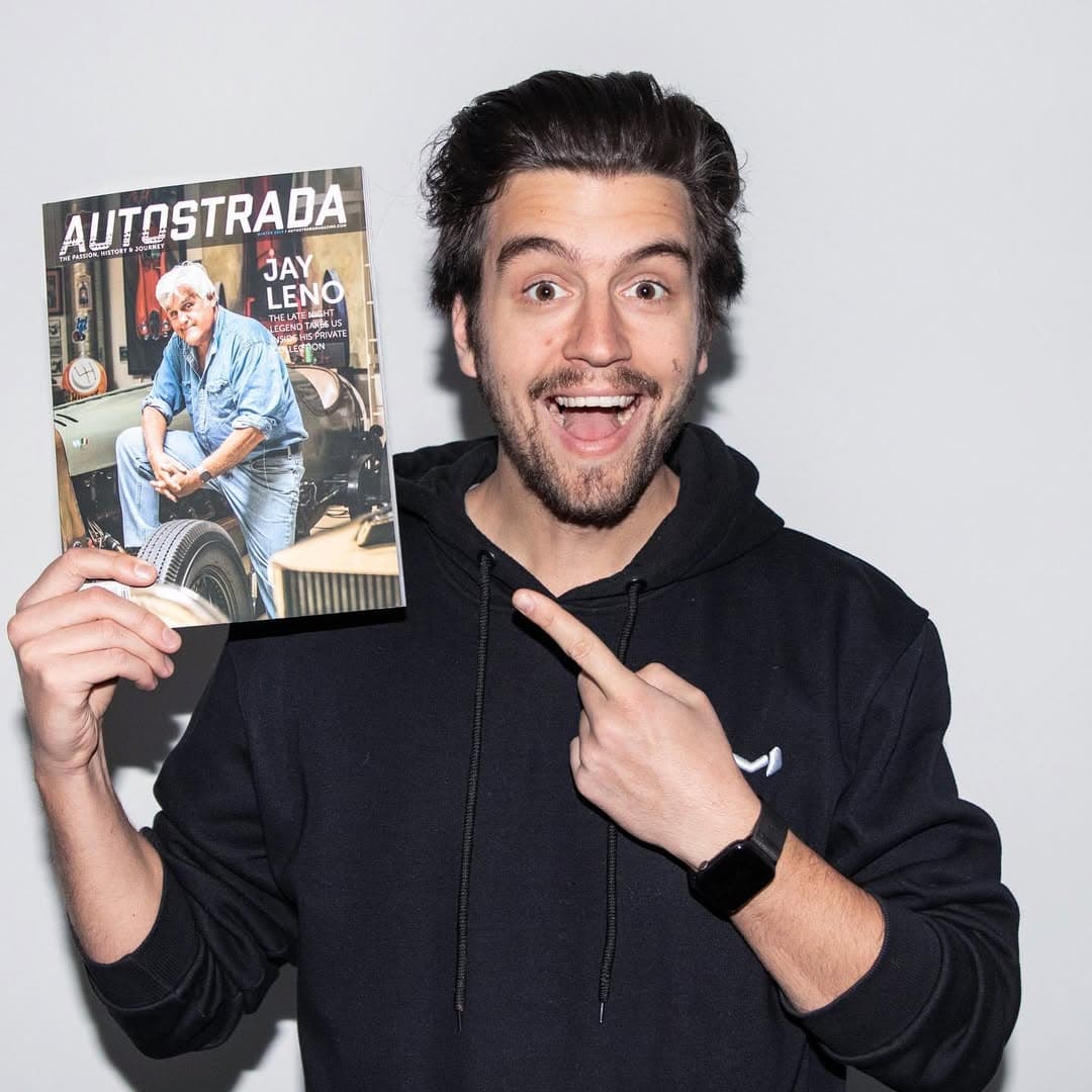 Holding an Autostrada Magazine issue with Jay Leno on its cover.