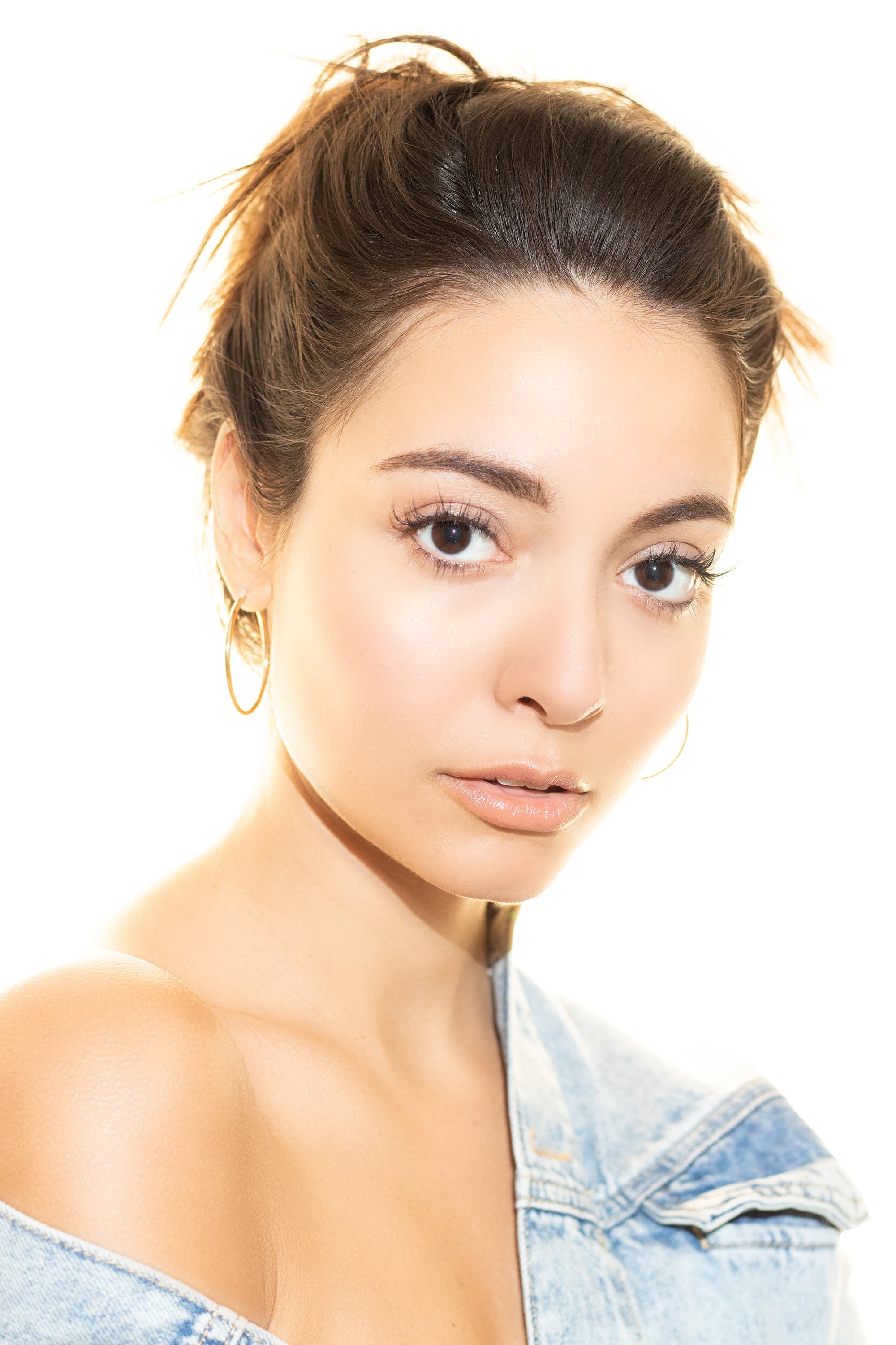 Close studio portrait of Natalie in a denim jacket.