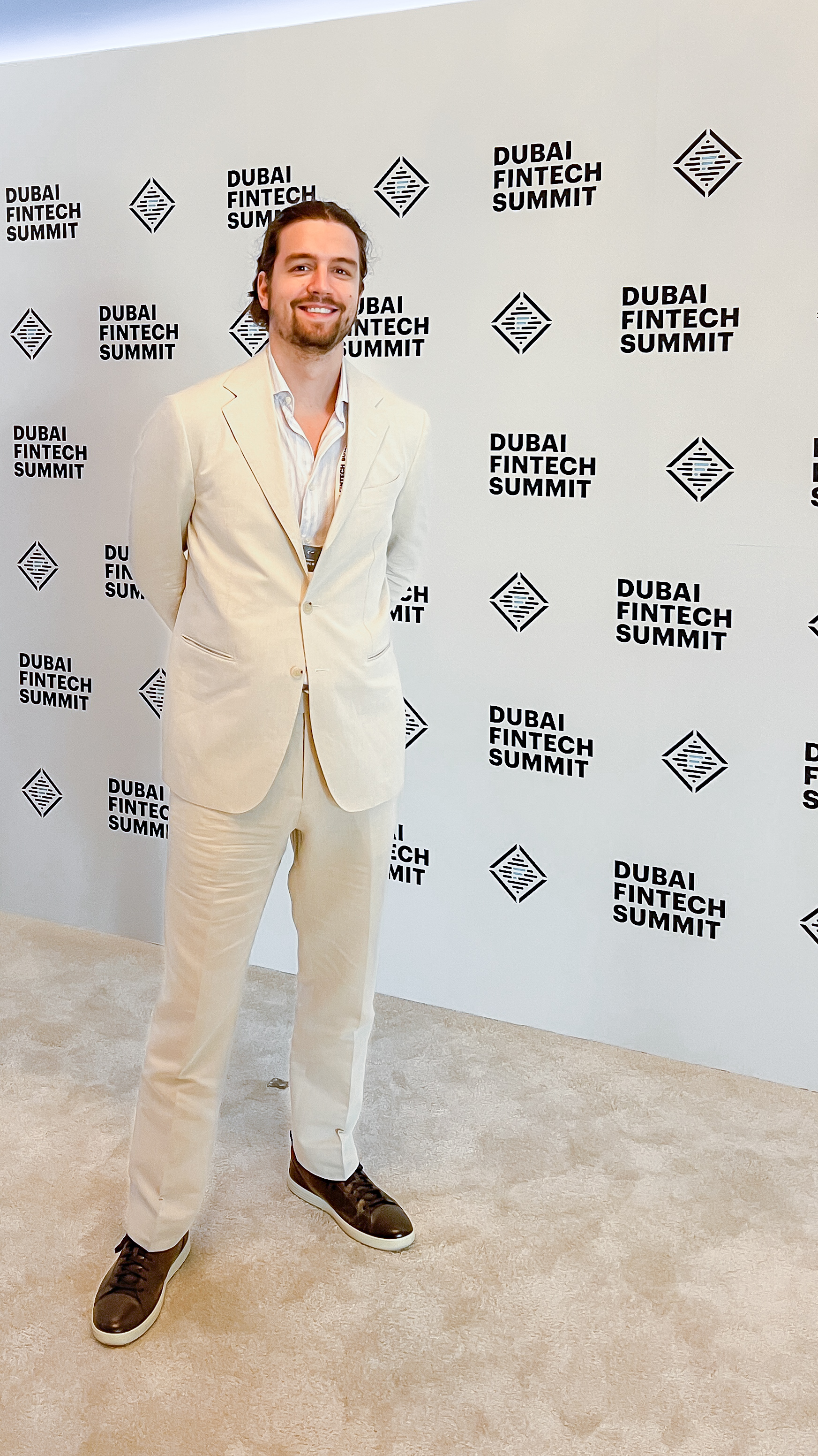 Zlatan Dujsic at the Dubai FinTech Summit, standing in front of the event backdrop.